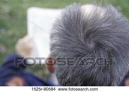 High angle view of a mature man reading a paper View Large Photo Image Picture - High angle view of a mature man reading a paper. Fotosearch