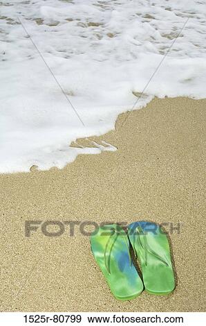 High angle view of a pair of flip-flops on the beach View Large Photo Image Stock Photo - High angle view of a pair of flip-flops on the beach. Fotosearch