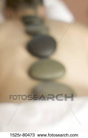 High angle view of a person getting hot stone massage therapy View Large Photo Image Stock Image - High angle view of a person getting hot stone massage therapy. Fotosearch