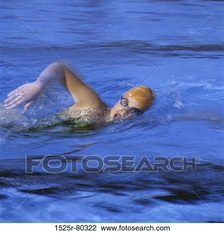 High angle view of a young woman swimming View Large Photo Image Stock Image - High angle view of a young woman swimming. Fotosearch