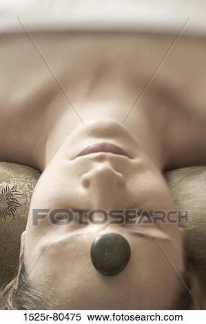 High angle view of a young woman getting hot stone massage therapy View Large Photo Image Stock Photography - High angle view of a young woman getting hot stone massage therapy. Fotosearch