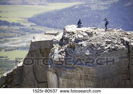 High angle view of two people on a cliff View Large Photo Image Stock Photo - High angle view of two people on a cliff. Fotosearch