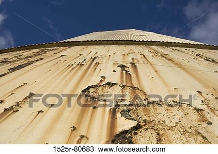Low angle view of a damaged wall View Large Photo Image Stock Image - Low angle view of a damaged wall. Fotosearch
