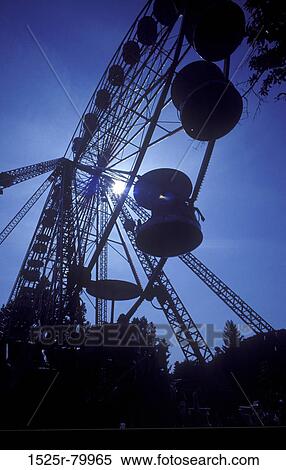Low angle view of a ferris wheel in an amusement park View Large Photo Image Stock Photography - Low angle view of a ferris wheel in an amusement park. Fotosearch