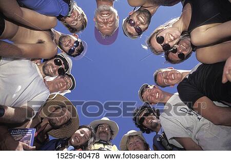 Low angle view of a group of people standing in a circle View Large Photo Image Stock Photo - Low angle view of a group of people standing in a circle. Fotosearch
