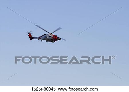 Low angle view of a helicopter in flight View Large Photo Image Stock Photography - Low angle view of a helicopter in flight. Fotosearch