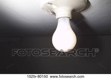 Low angle view of a light bulb lit up View Large Photo Image Stock Image - Low angle view of a light bulb lit up. Fotosearch