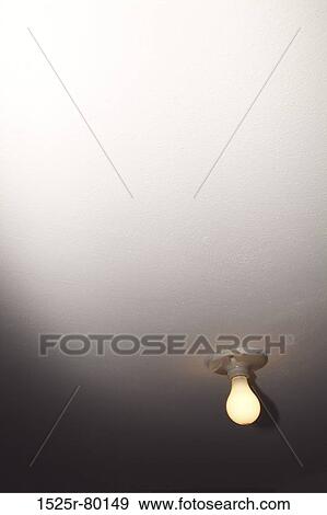 Low angle view of a light bulb lit up View Large Photo Image Stock Photo - Low angle view of a light bulb lit up. Fotosearch