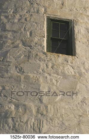 Stock Photograph - Low angle view of a window on a wall. Fotosearch