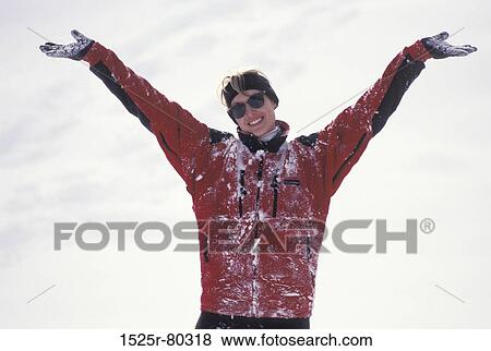 Low angle view of a young woman smiling with her arms outstretched View Large Photo Image Stock Photo - Low angle view of a young woman smiling with her arms outstretched. Fotosearch