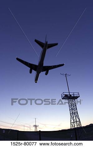 Low angle view of an airplane in flight View Large Photo Image Stock Photo - Low angle view of an airplane in flight. Fotosearch