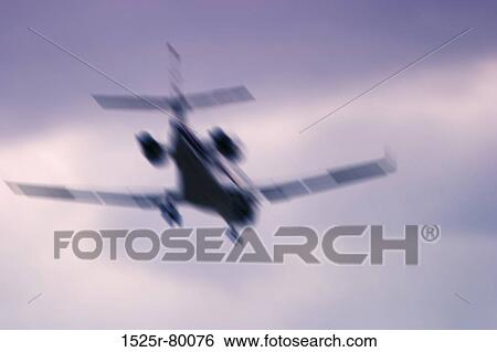 Low angle view of an airplane in flight View Large Photo Image Stock Photograph - Low angle view of an airplane in flight. Fotosearch