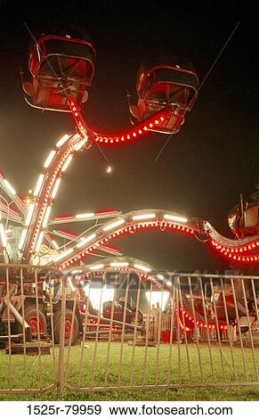 Low angle view of an amusement park ride lit up at night View Large Photo Image Stock Photo - Low angle view of an amusement park ride lit up at night. Fotosearch