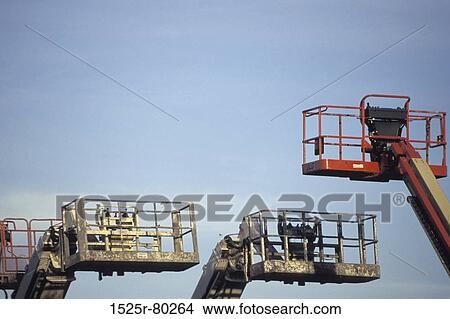 Low angle view of three cranes View Large Photo Image Picture - Low angle view of three cranes. Fotosearch