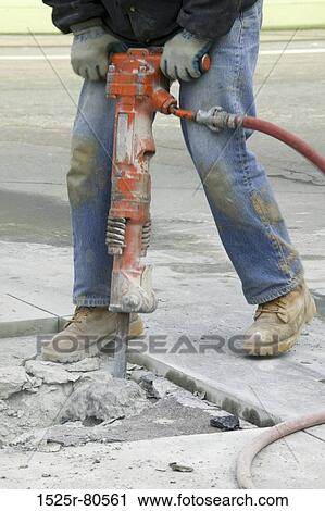 Low section view of a man operating a jackhammer on the road View Large Photo Image Stock Image - Low section view of a man operating a jackhammer on the road. Fotosearch