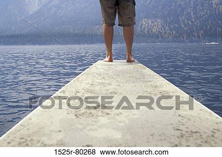 Low section view of a person standing on a pier View Large Photo Image Stock Photo - Low section view of a person standing on a pier. Fotosearch
