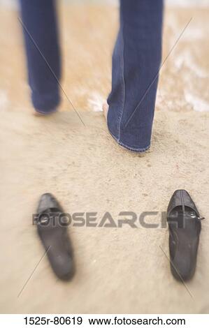 Low section view of a person standing on the beach View Large Photo Image Stock Photo - Low section view of a person standing on the beach. Fotosearch