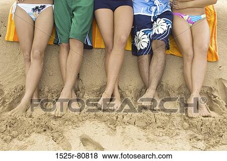 Low section view of three women and two men standing on the beach View Large Photo Image Stock Photo - Low section view of three women and two men standing on the beach. Fotosearch