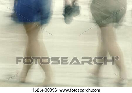 Low section view of two people walking on the beach View Large Photo Image Stock Photograph - Low section view of two people walking on the beach. Fotosearch