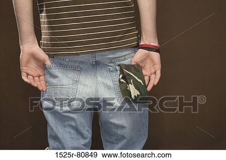 Mid section view of a man standing with his hands in pockets View Large Photo Image Stock Photo - Mid section view of a man standing with his hands in pockets. Fotosearch