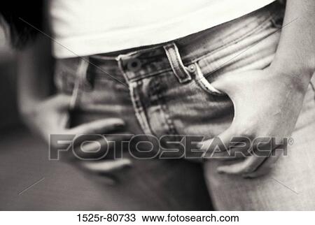 Mid section view of a person with his thumbs in his pockets View Large Photo Image Stock Image - Mid section view of a person with his thumbs in his pockets. Fotosearch