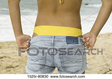 Mid section view of a woman getting dressed View Large Photo Image Stock Image - Mid section view of a woman getting dressed. Fotosearch