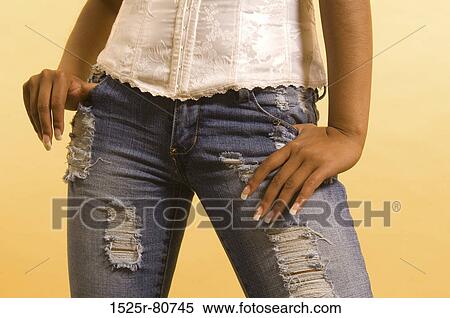 Mid section view of a woman standing with her hands in her pockets View Large Photo Image Stock Photography - Mid section view of a woman standing with her hands in her pockets. Fotosearch