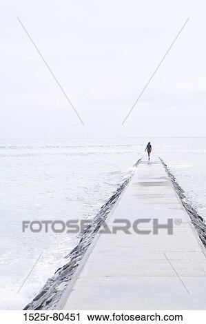 Person standing on a jetty View Large Photo Image Stock Image - Person standing on a jetty. Fotosearch