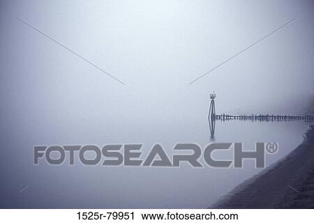 Stock Image - Pier and a watch tower on a lake. Fotosearch