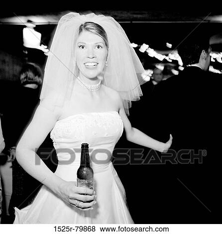 Stock Photo - Portrait of a bride holding a beer bottle. Fotosearch