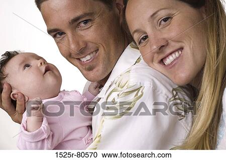 Portrait of a father holding his son and smiling with his wife View Large Photo Image Stock Image - Portrait of a father holding his son and smiling with his wife. Fotosearch