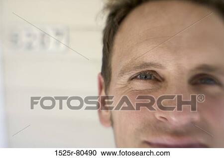Stock Image - Portrait of a mid adult man smirking. Fotosearch
