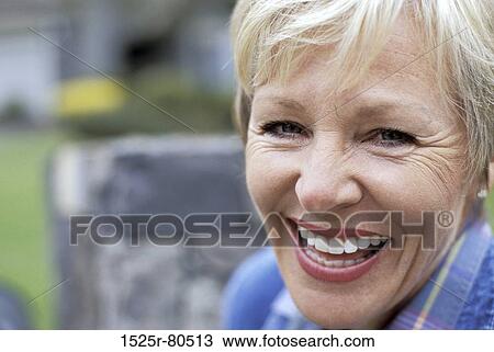 Portrait of a senior woman smiling View Large Photo Image Stock Image - Portrait of a senior woman smiling. Fotosearch