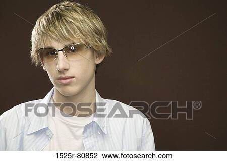 Portrait of a teenage boy wearing eyeglasses View Large Photo Image Stock Image - Portrait of a teenage boy wearing eyeglasses. Fotosearch