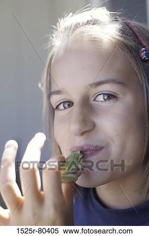 Portrait of a teenage girl kissing a frog View Large Photo Image Stock Photography - Portrait of a teenage girl kissing a frog. Fotosearch