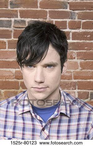 Portrait of a young man looking serious View Large Photo Image Stock Image - Portrait of a young man looking serious. Fotosearch