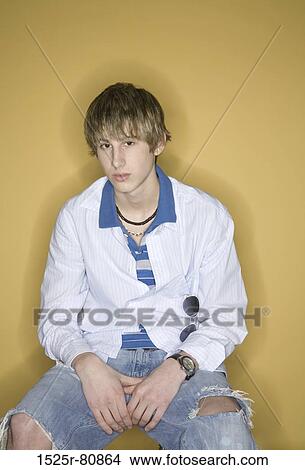 Picture - Portrait of a young man sitting. Fotosearch