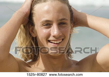 Portrait of a young man smiling View Large Photo Image Stock Photo - Portrait of a young man smiling. Fotosearch