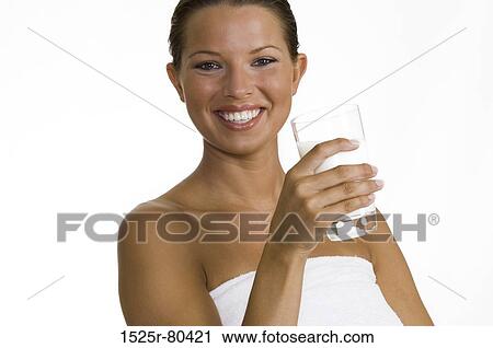 Portrait of a young woman holding a glass of milk View Large Photo Image Stock Image - Portrait of a young woman holding a glass of milk. Fotosearch