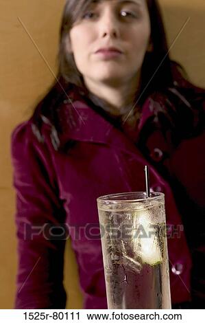 Portrait of a young woman in front of a glass of water View Large Photo Image Stock Image - Portrait of a young woman in front of a glass of water. Fotosearch