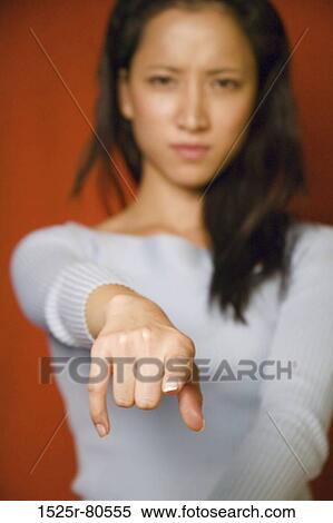 Portrait of a young woman pointing forward View Large Photo Image Stock Photography - Portrait of a young woman pointing forward. Fotosearch