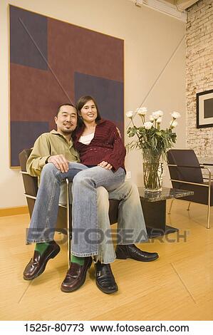 Portrait of a young woman sitting on a young man's lap View Large Photo Image Stock Image - Portrait of a young woman sitting on a young man's lap. Fotosearch