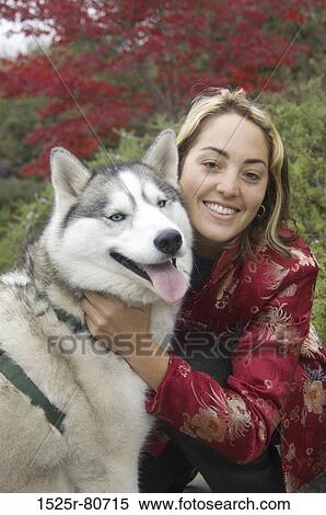 Portrait of a young woman with her dog View Large Photo Image Stock Photography - Portrait of a young woman with her dog. Fotosearch