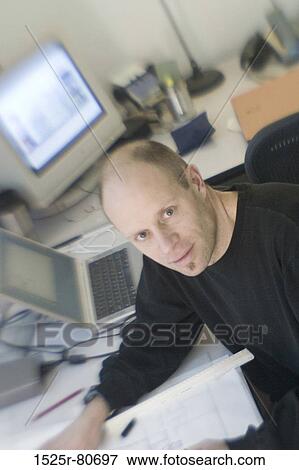 Portrait of an architect sitting in an office View Large Photo Image Stock Photo - Portrait of an architect sitting in an office. Fotosearch
