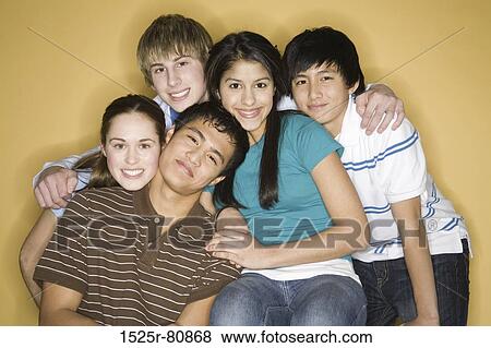 Stock Photo - Portrait of three young men with two young women smiling. Fotosearch