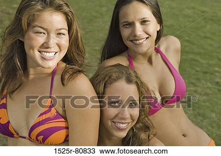 Portrait of three young women in a lawn View Large Photo Image Stock Image - Portrait of three young women in a lawn. Fotosearch