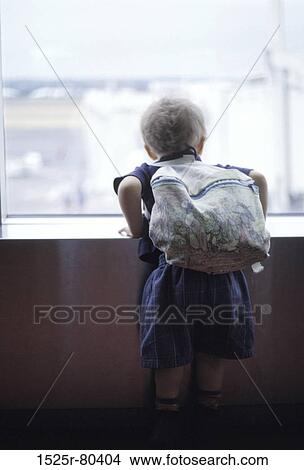 Rear view of a boy leaning on a wall View Large Photo Image Picture - Rear view of a boy leaning on a wall. Fotosearch