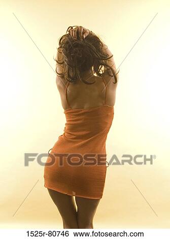 Rear view of a woman posing View Large Photo Image Stock Photograph - Rear view of a woman posing. Fotosearch