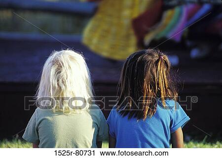 Stock Image - Rear view of two girls. Fotosearch