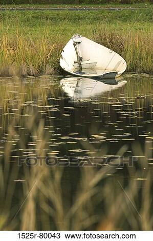 Stock Image - Reflection of a boat in water. Fotosearch